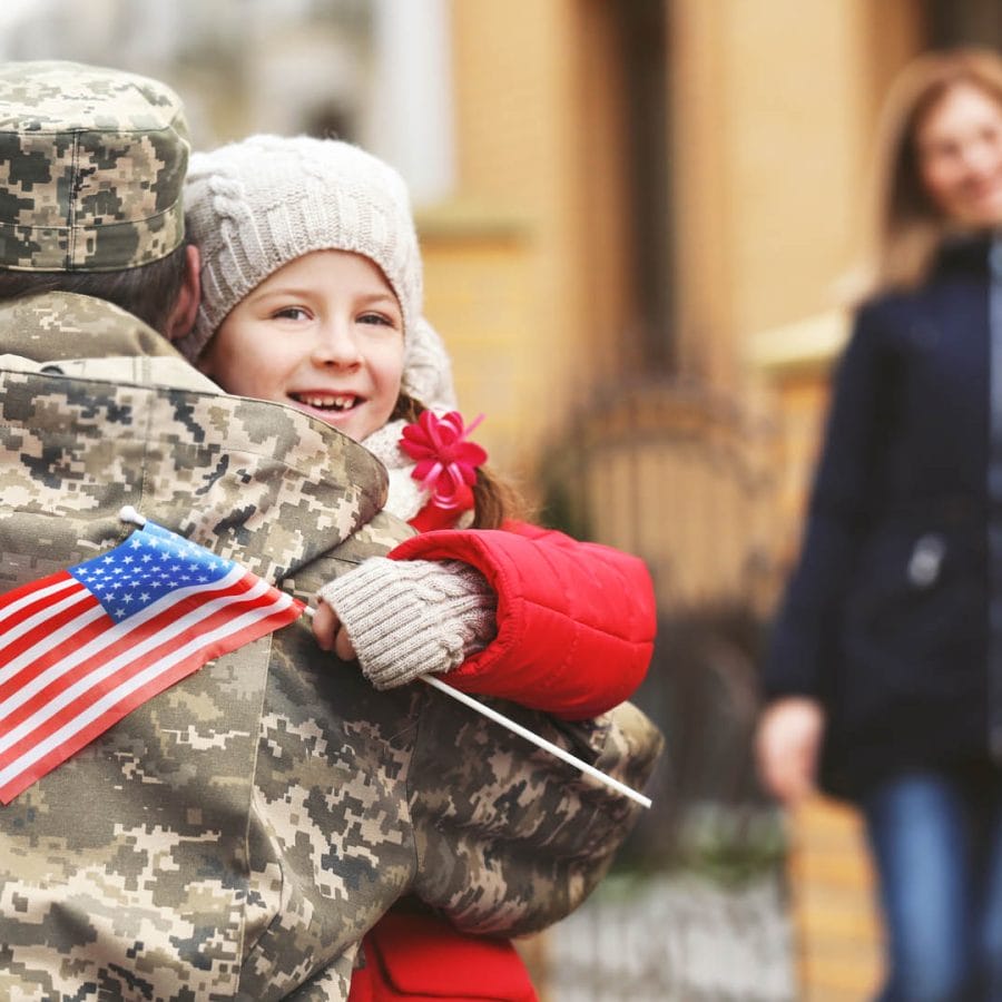 Happy reunion of soldier with family outdoors